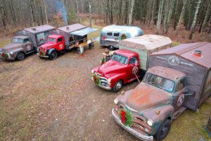 This photo shows off the four trucks and one Air Stream trailer in the Rustic Taps fleet.