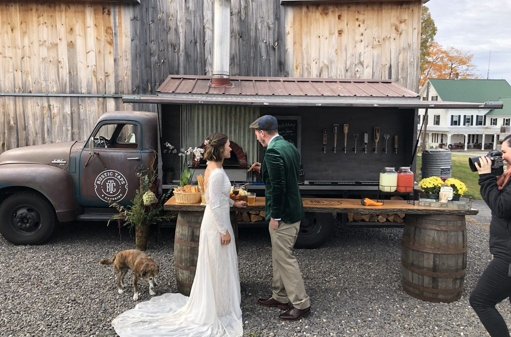 Bride and groom in front of their pizza & beer food truck
