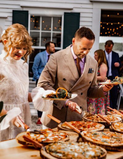Newly weds getting pizza from rustic taps bar set up
