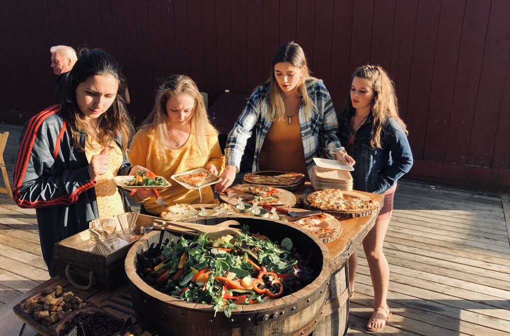 A crowd of young women enjoying catering from Rustic Taps Pizza Trucks